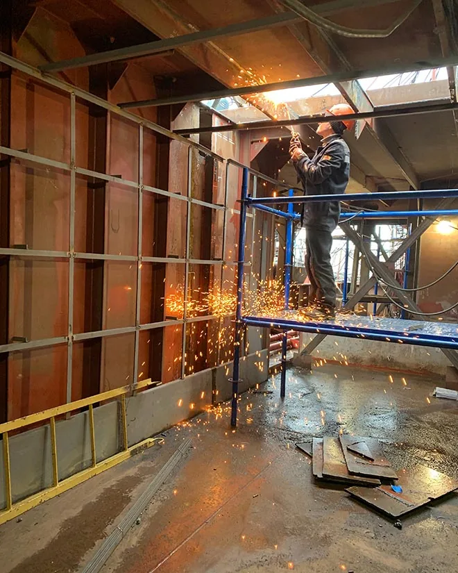 Technician performing commercial building maintenance and repair